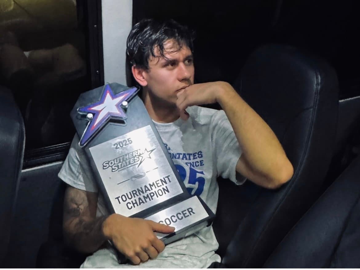 Lorenzo Peluso holding a tournament champion trophy